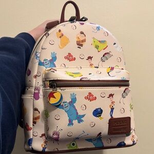 Loungefly Pixar Backpack Sully Woody Dug Nemo Walle- Cream and brown